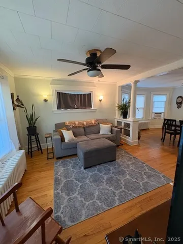 a living room with furniture and wooden floor