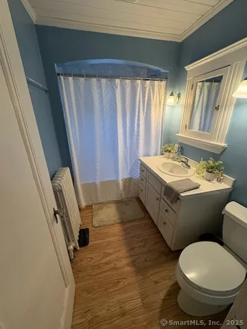 a bathroom with a double vanity sink toilet and a mirror