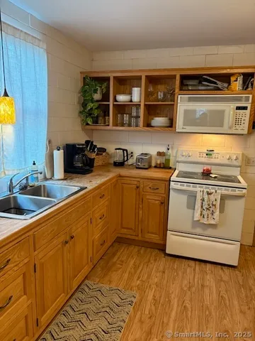 a kitchen with stainless steel appliances a stove a sink and a microwave