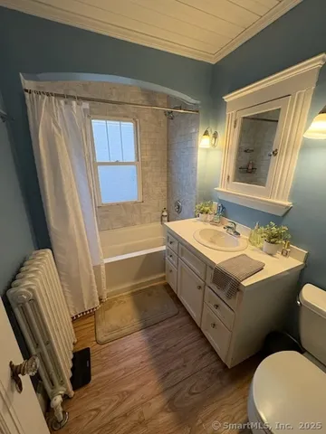a bathroom with a sink mirror vanity and toilet