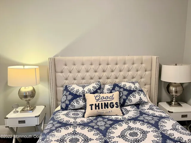 a bedroom with a bed and a lamp