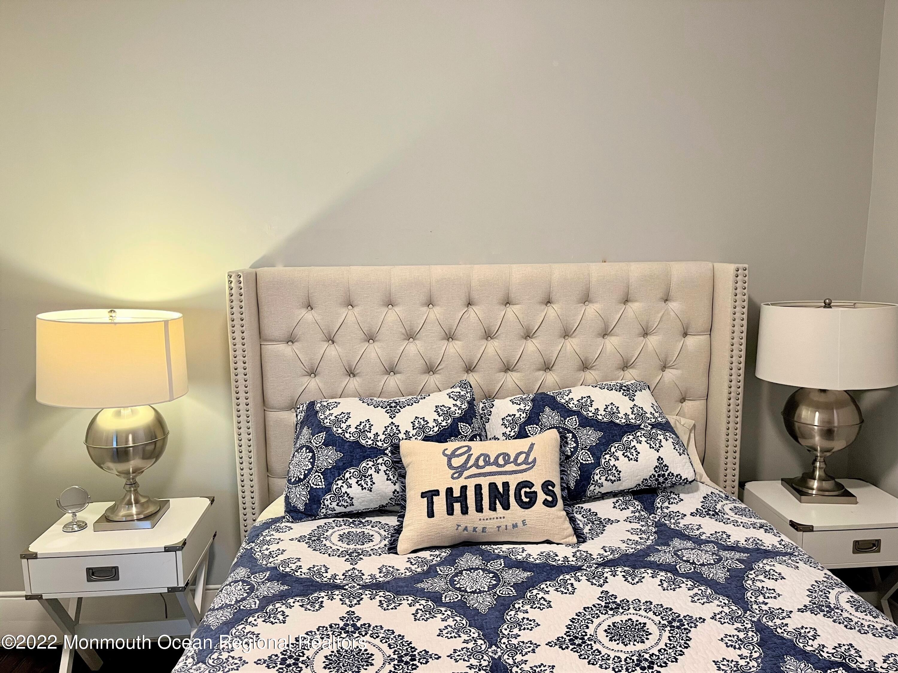 216 Main Street, Unit UP Avon-by-the-Sea, NJ 07717 - Photo 11 of 20 a bedroom with a bed and a lamp