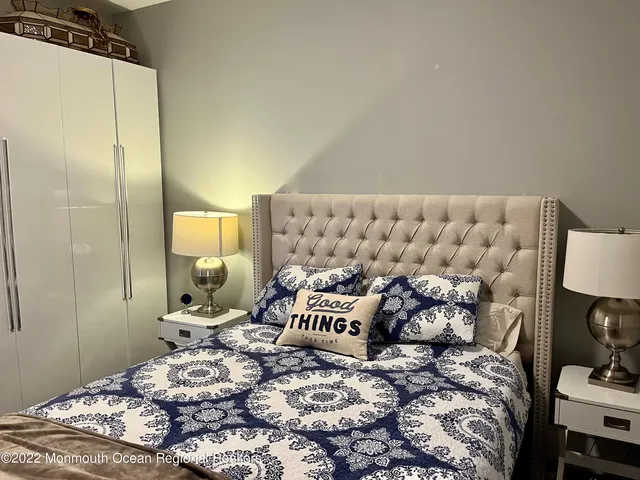 a bedroom with a bed and a lamp