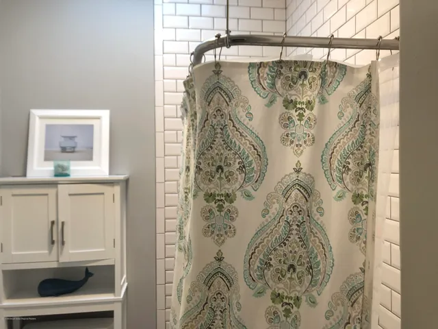 a bathroom with a shower and a window