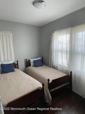 a bedroom with two beds and a window