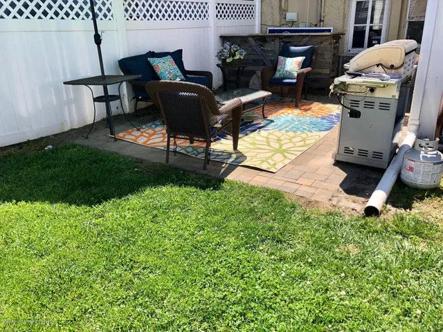 a view of a backyard with furniture and a fireplace