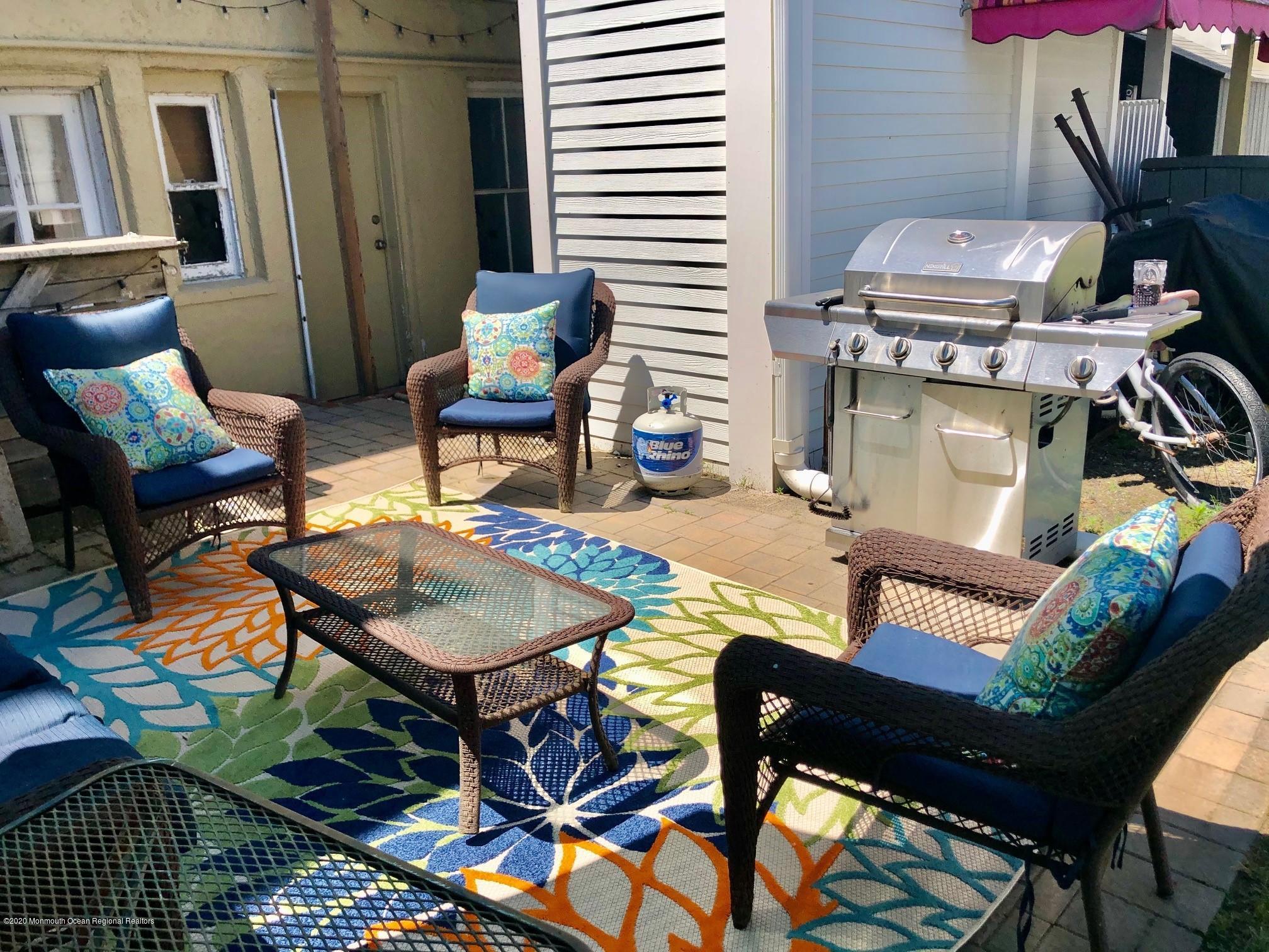 216 Main Street, Unit UP Avon-by-the-Sea, NJ 07717 - Photo 17 of 20 a living room with furniture and a fireplace