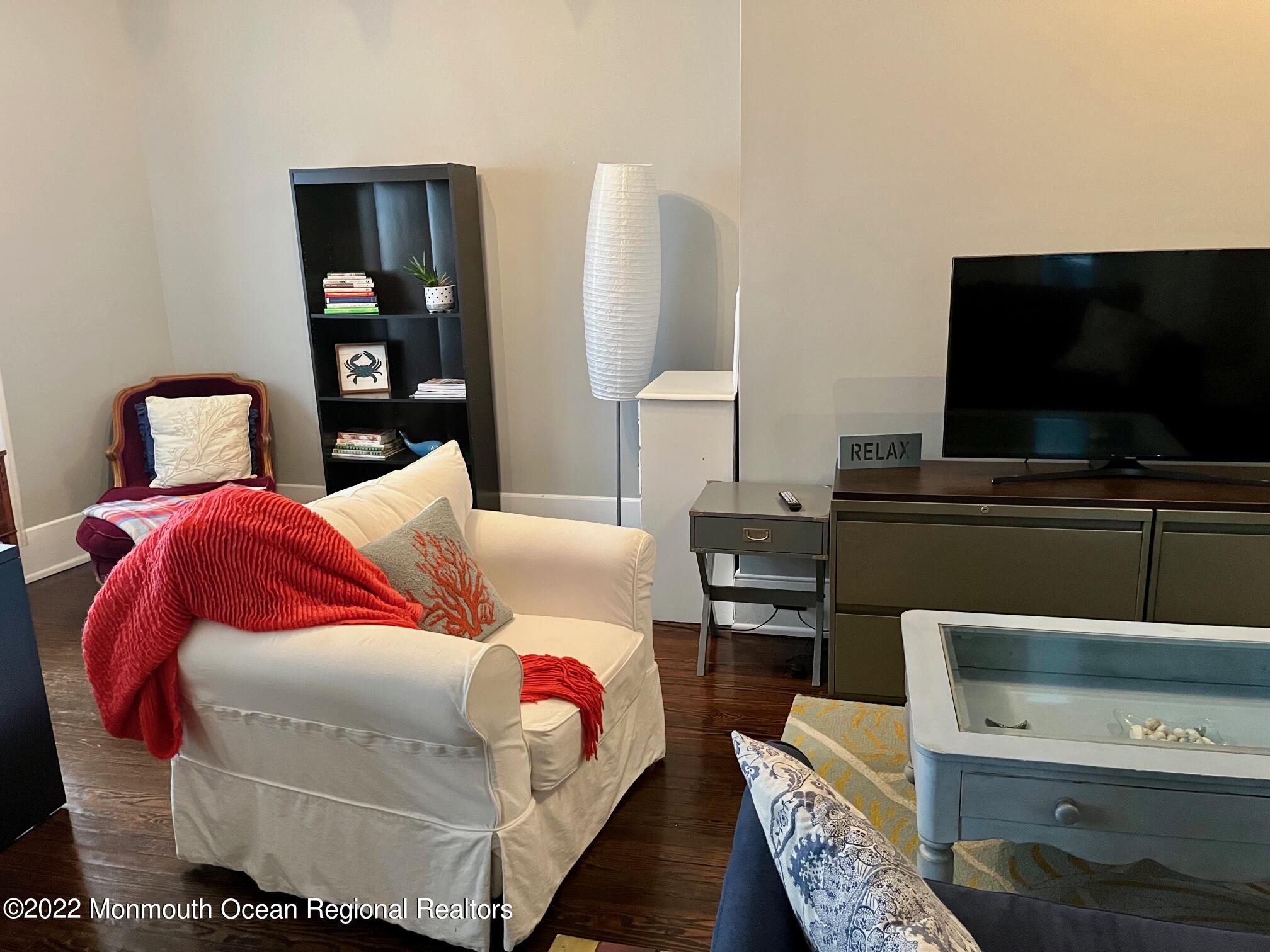 216 Main Street, Unit UP Avon-by-the-Sea, NJ 07717 - Photo 9 of 20 a living room with furniture and a flat screen tv