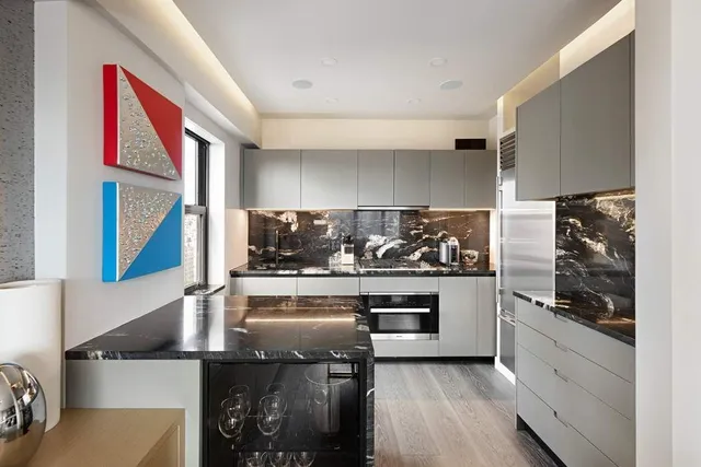 a kitchen with stainless steel appliances granite countertop a sink and wooden cabinets