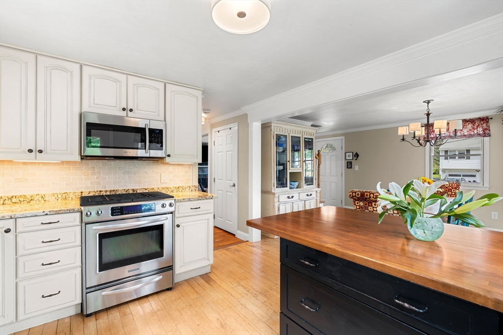 35 Spallus Road Stoughton, MA 02072 - Photo 20 of 39 a kitchen with granite countertop a stove a sink and a white cabinets