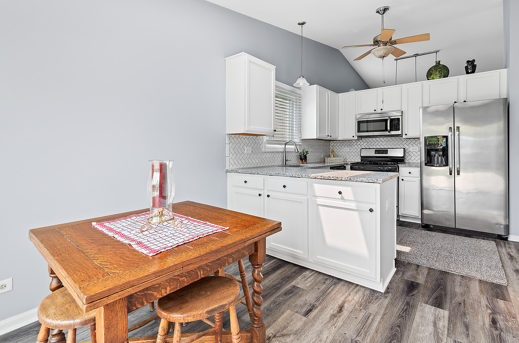 126 Dickens Trail Elgin, IL 60120 - Photo 11 of 23 a kitchen with stainless steel appliances granite countertop a stove a sink dishwasher and a refrigerator