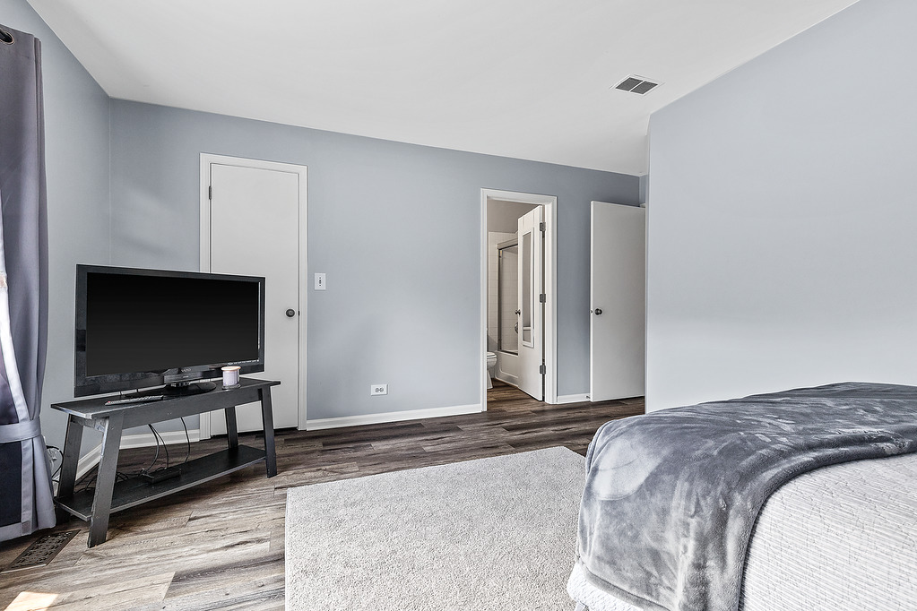 126 Dickens Trail Elgin, IL 60120 - Photo 12 of 23 a bedroom with a flat screen tv and a window