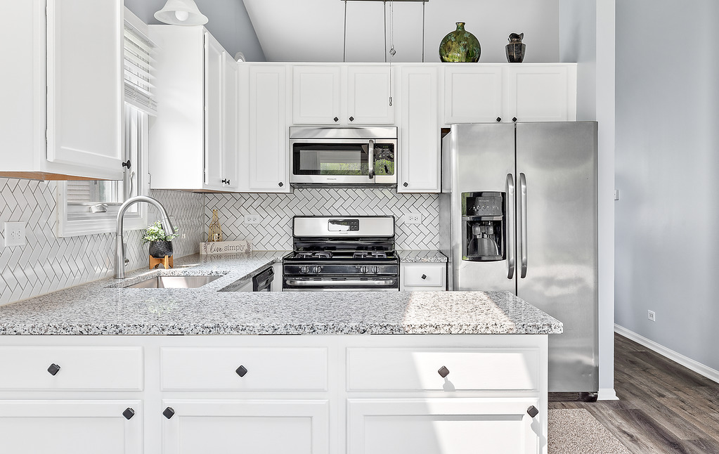 126 Dickens Trail Elgin, IL 60120 - Photo 8 of 23 a kitchen with stainless steel appliances granite countertop a sink stove and refrigerator