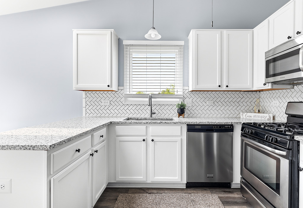 126 Dickens Trail Elgin, IL 60120 - Photo 9 of 23 a kitchen with granite countertop white cabinets white stainless steel appliances and a sink