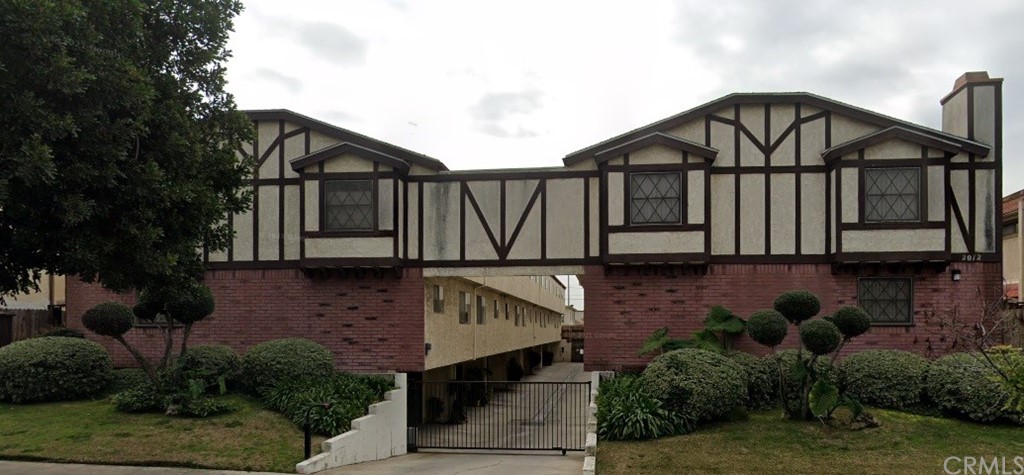 a view of a house with wooden fence