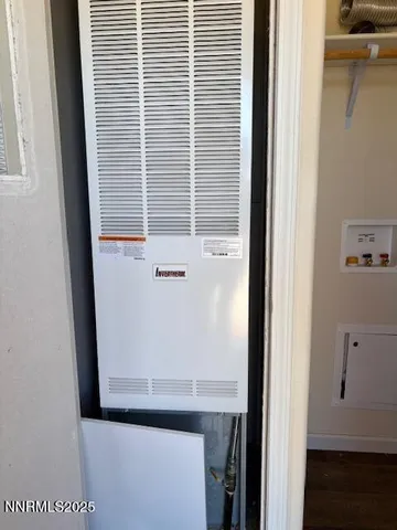 a view of a dry yard with wooden fence