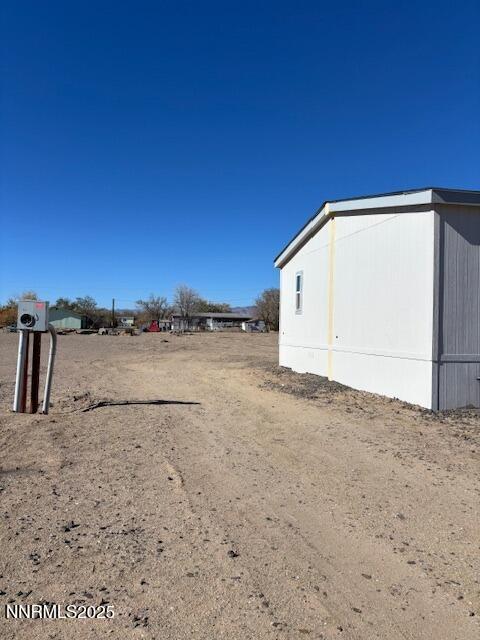 3599 Ardmore Street Silver Springs, NV 89429 - Photo 22 of 29 a view of a dry yard with wooden fence