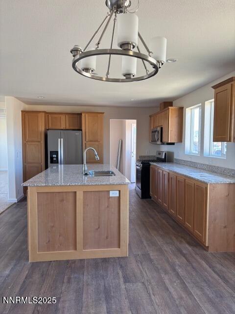 3599 Ardmore Street Silver Springs, NV 89429 - Photo 3 of 29 a large kitchen with stainless steel appliances granite countertop a stove a sink dishwasher and a refrigerator with wooden floor