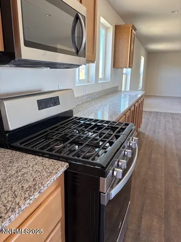 a close view of a stove a microwave and cabinets