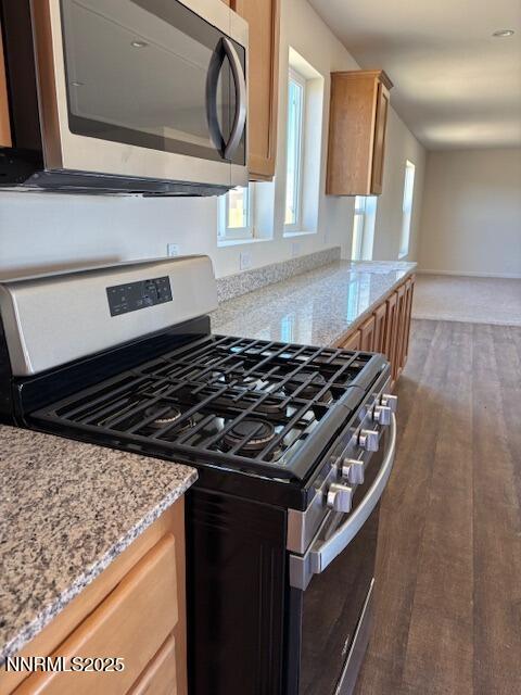 3599 Ardmore Street Silver Springs, NV 89429 - Photo 5 of 29 a close view of a stove a microwave and cabinets
