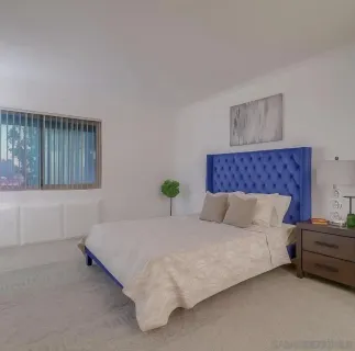 a bedroom with a bed dresser and a window