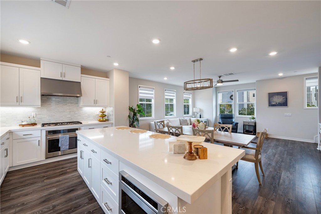 6 Pony Court Rancho Mission Viejo, CA 92694 - Photo 11 of 35 a large kitchen with stainless steel appliances lots of counter space and wooden floor