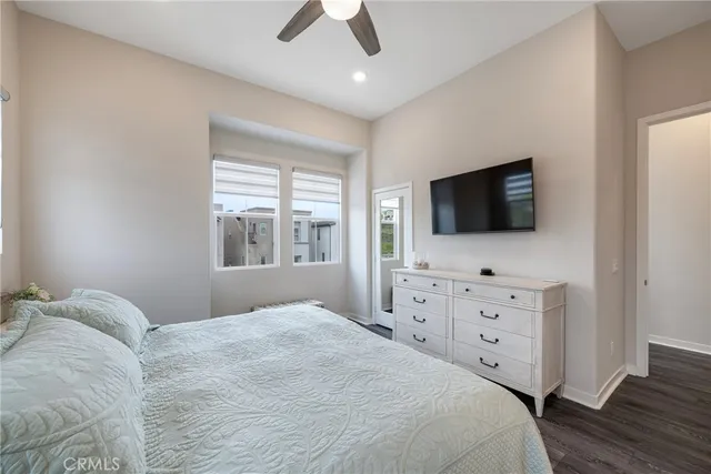 a bedroom with a flat screen television and a bed