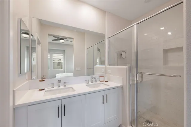 a bathroom with a sink double vanity and a mirror