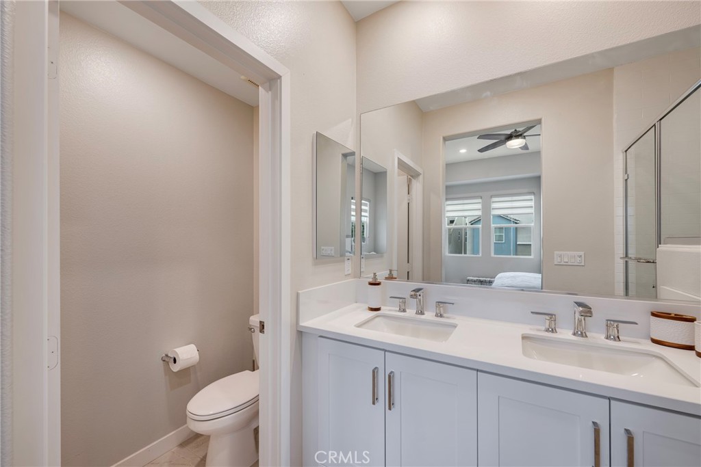 6 Pony Court Rancho Mission Viejo, CA 92694 - Photo 17 of 35 a bathroom with a sink a toilet and a large mirror