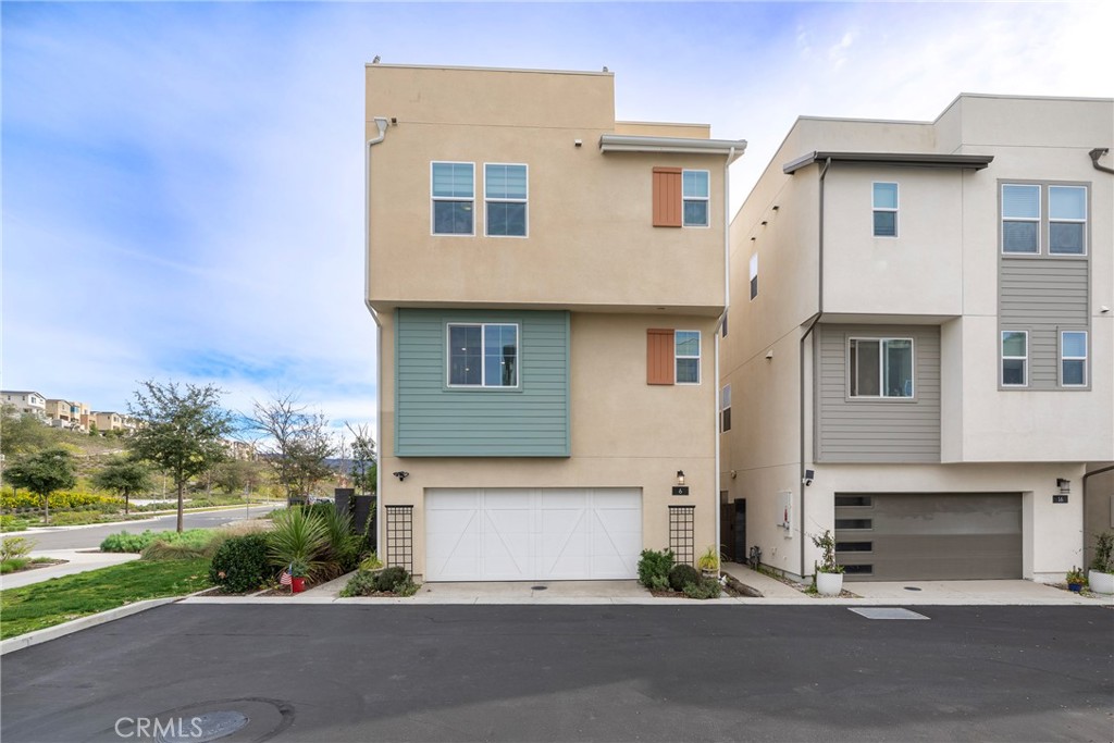 6 Pony Court Rancho Mission Viejo, CA 92694 - Photo 24 of 35 a front view of a house with a yard and garage