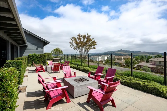 a view of a chairs and table in patio with a yard