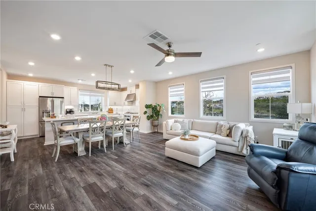 a living room with lots of furniture and kitchen view