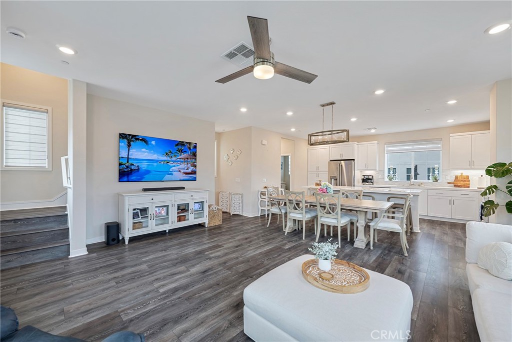 6 Pony Court Rancho Mission Viejo, CA 92694 - Photo 7 of 35 a living room with furniture a dining table wooden floor and a fireplace