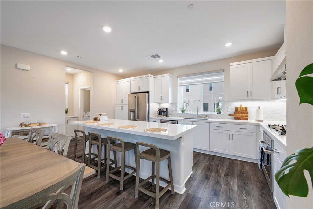 6 Pony Court Rancho Mission Viejo, CA 92694 - Photo 8 of 35 a kitchen with appliances a sink a table and chairs in it