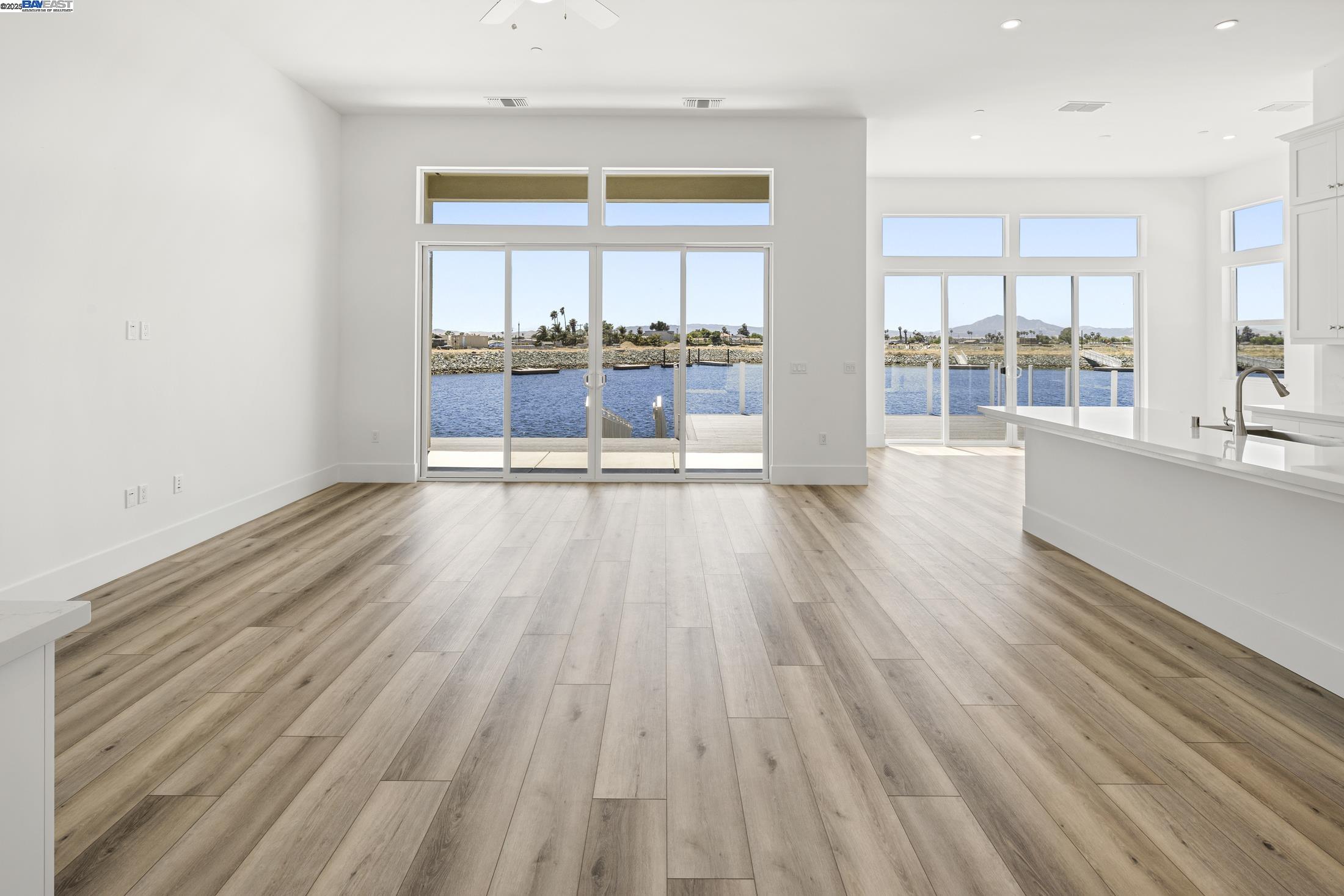 6008 Windsweep Road Bethel Island, CA 94511 - Photo 8 of 21 an empty room with wooden floor and windows