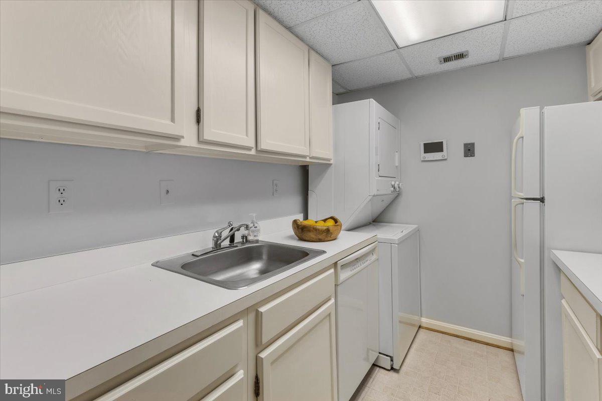 208 Justice Court Northeast, Unit 44 Washington, DC 20002 - Photo 12 of 26 a kitchen with stainless steel appliances a sink a refrigerator and cabinets
