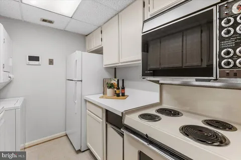 a kitchen with a sink a stove and a refrigerator