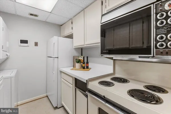 a kitchen with a sink a stove and a refrigerator