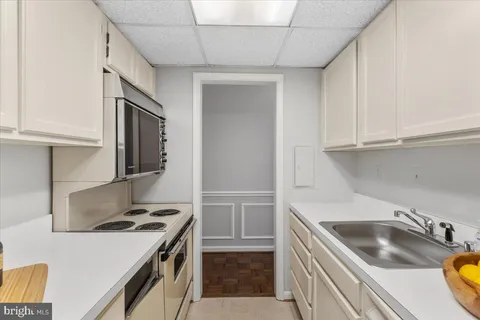 a kitchen that has a sink and a stove