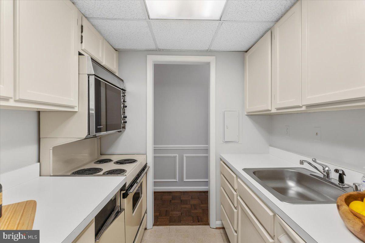 208 Justice Court Northeast, Unit 44 Washington, DC 20002 - Photo 14 of 26 a kitchen that has a sink and a stove