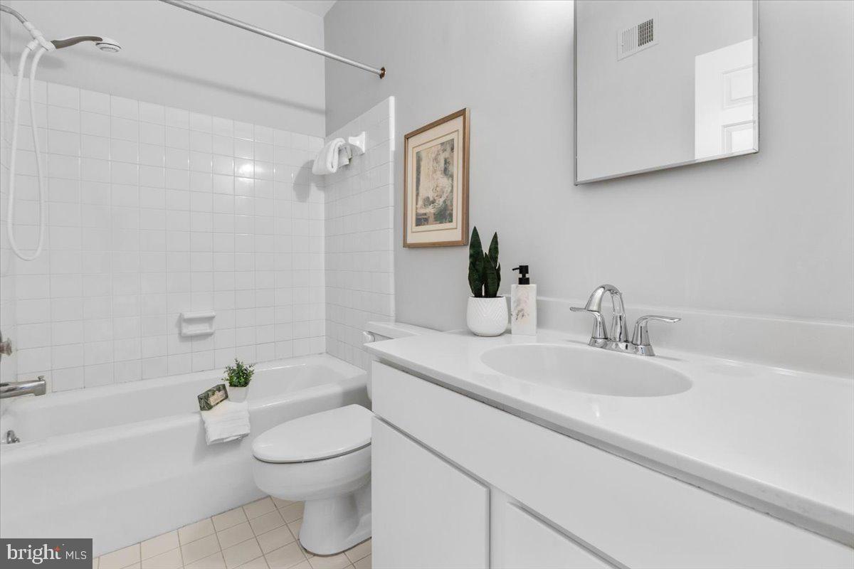 208 Justice Court Northeast, Unit 44 Washington, DC 20002 - Photo 20 of 26 a bathroom with a granite countertop sink a toilet and shower