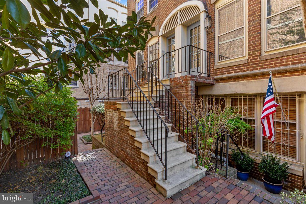 208 Justice Court Northeast, Unit 44 Washington, DC 20002 - Photo 23 of 26 a view of a brick house with plants next to a road