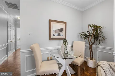 a view of a dining room with furniture and wooden floor