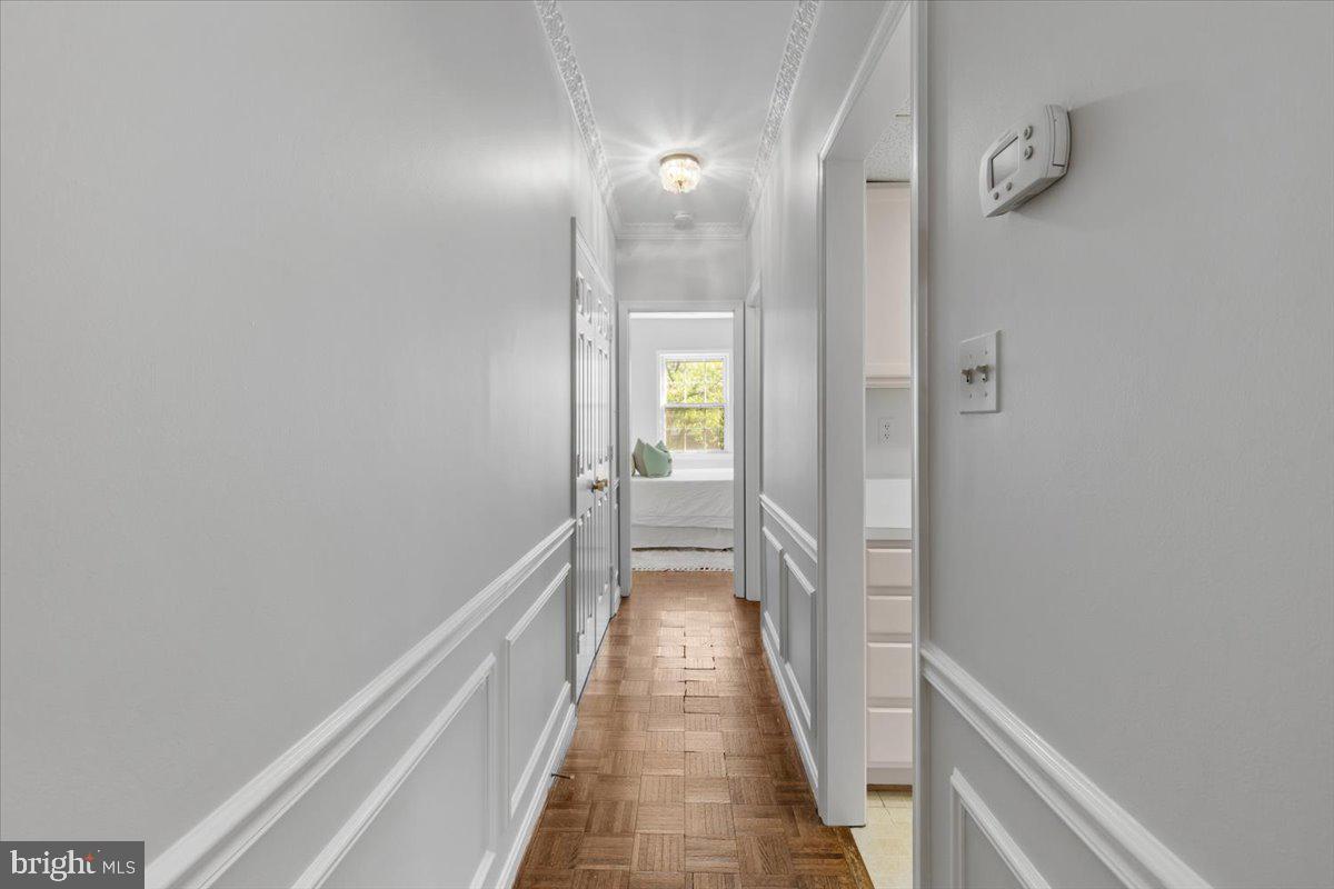 208 Justice Court Northeast, Unit 44 Washington, DC 20002 - Photo 10 of 26 a view of a hallway with wooden floor and a bathroom