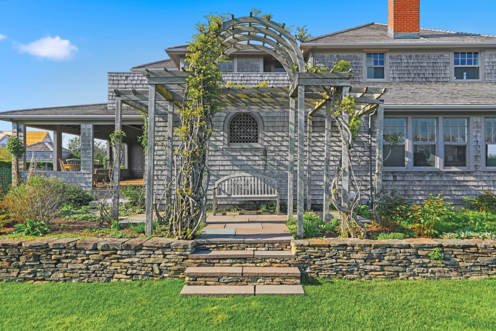 59 Baxter Road Nantucket, MA 02554 - Photo 8 of 8 a front view of a house with a garden