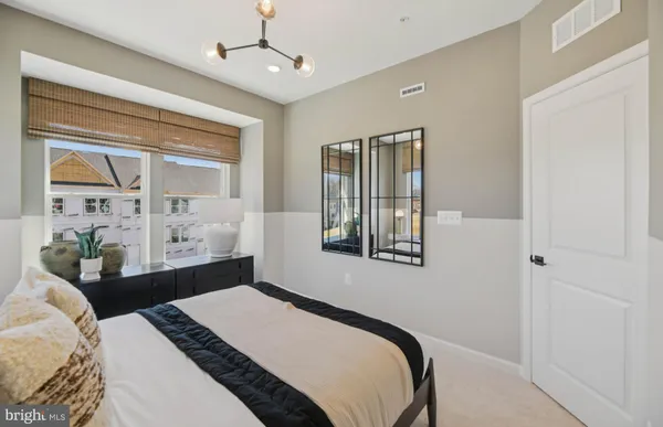 a bedroom with a bed lamps and window