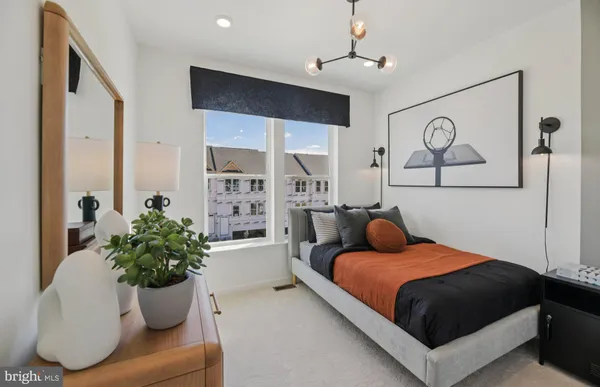 a bedroom with a bed couch and window