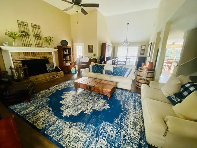 a living room with furniture and a fireplace