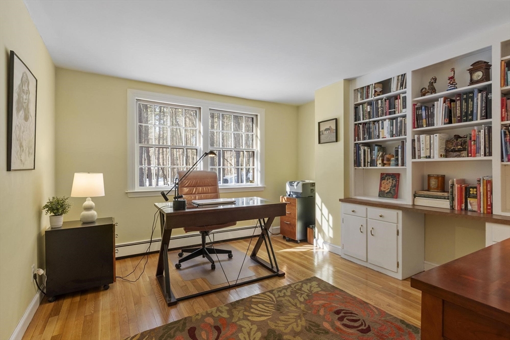 265 College Road Concord, MA 01742 - Photo 19 of 42 a workspace with furniture bookshelf and wooden floor