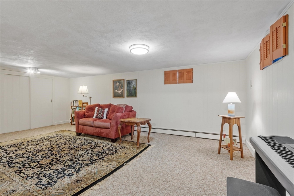 265 College Road Concord, MA 01742 - Photo 33 of 42 a living room with furniture rug and lamp
